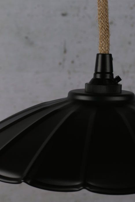 Close up of black umbrella pendant light with jute cord.
