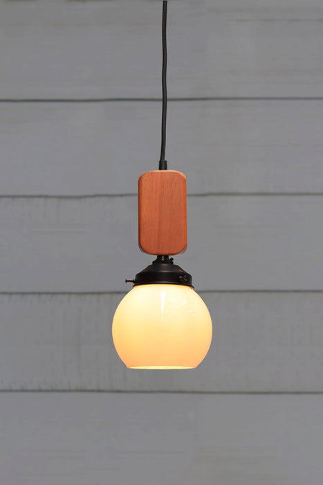small open glass pendant with wooden block cord