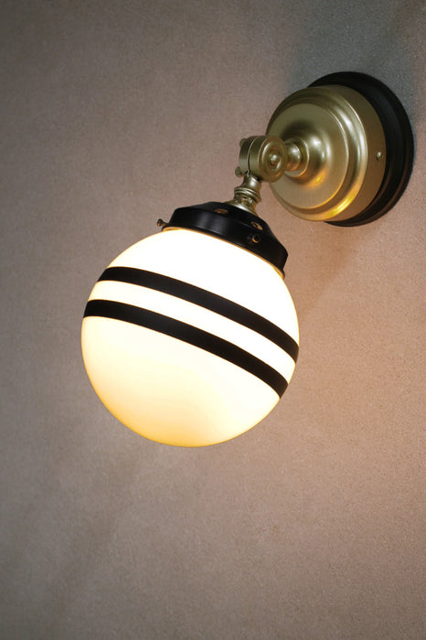Gold brass wall light with black gallery and mounting block with opal glass shade with two stripes