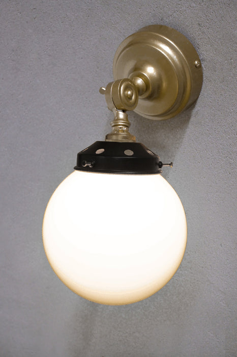 Gold brass wall light with black gallery and opal glass shade