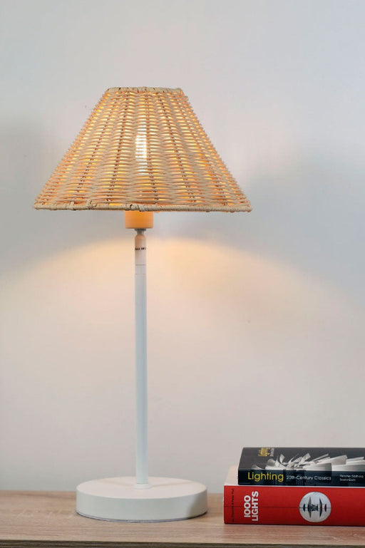 rattan table lamp over a bedside table