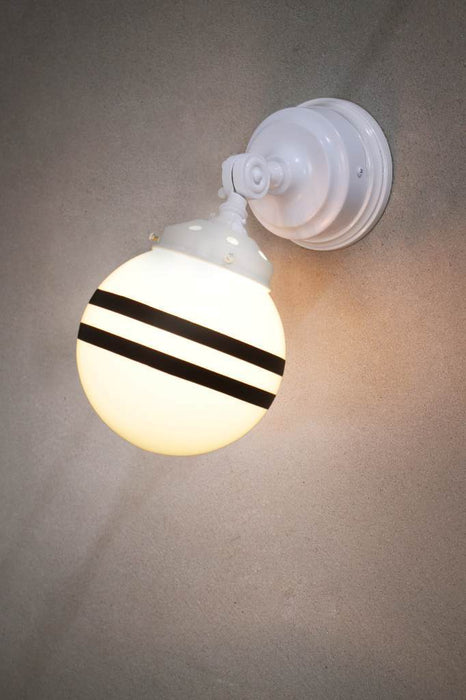White wall light with white gallery and opal shade with two stripes against a concrete background