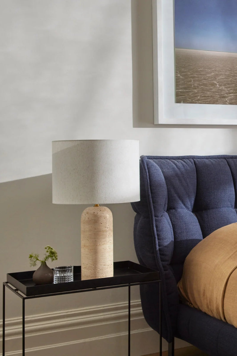 Travertine table lamp with drum shade as a bedside table. 