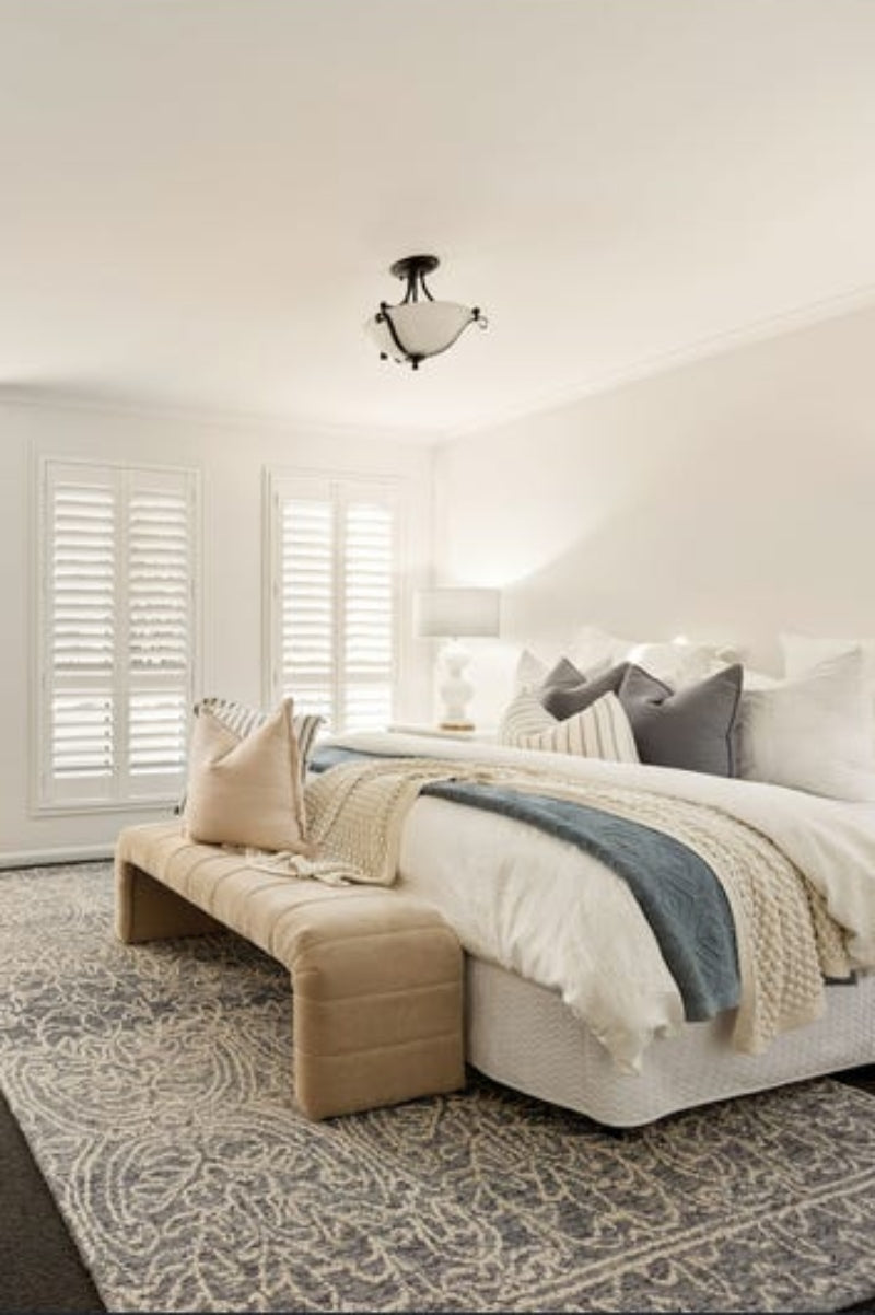 Metal and glass ceiling light in a bedroom. 