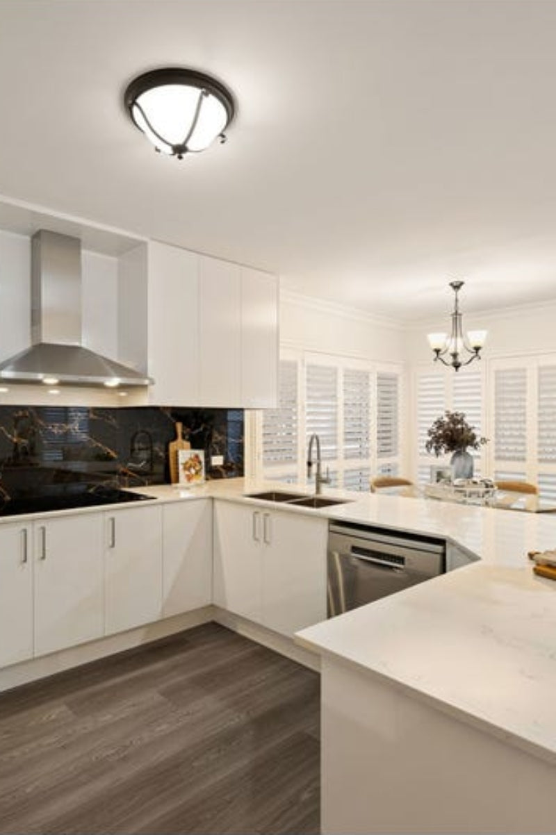 Metal and glass ceiling light in a kitchen. 