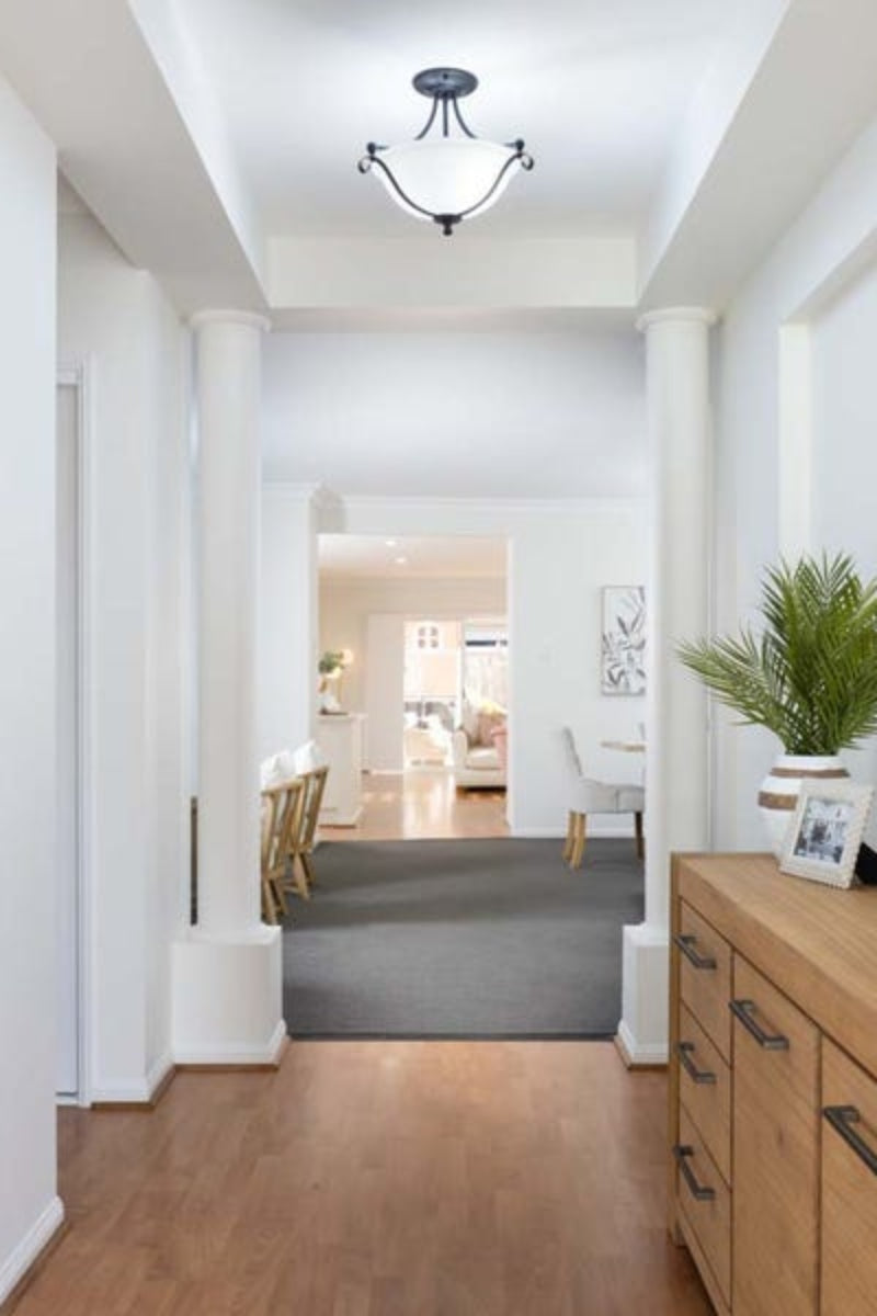 Metal and glass ceiling light in an entranceway. 