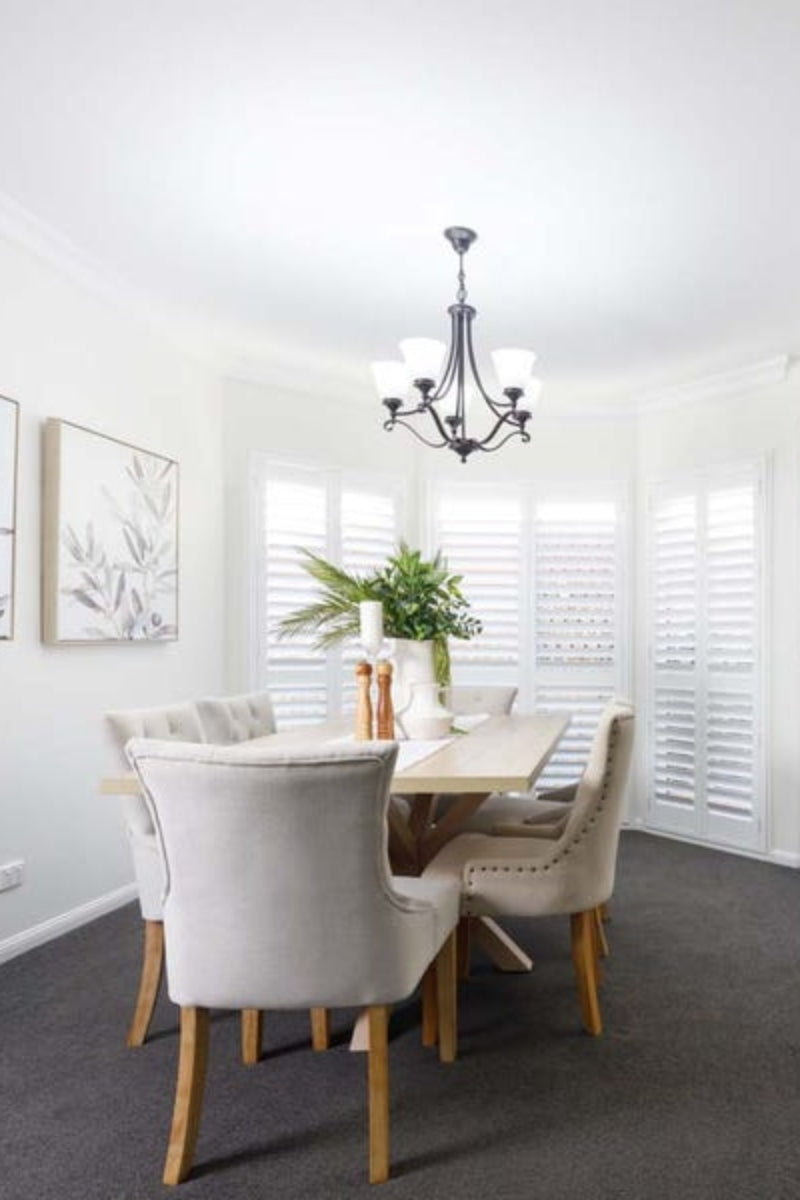 5 light Mandeville Chandelier over a bright dining room. 