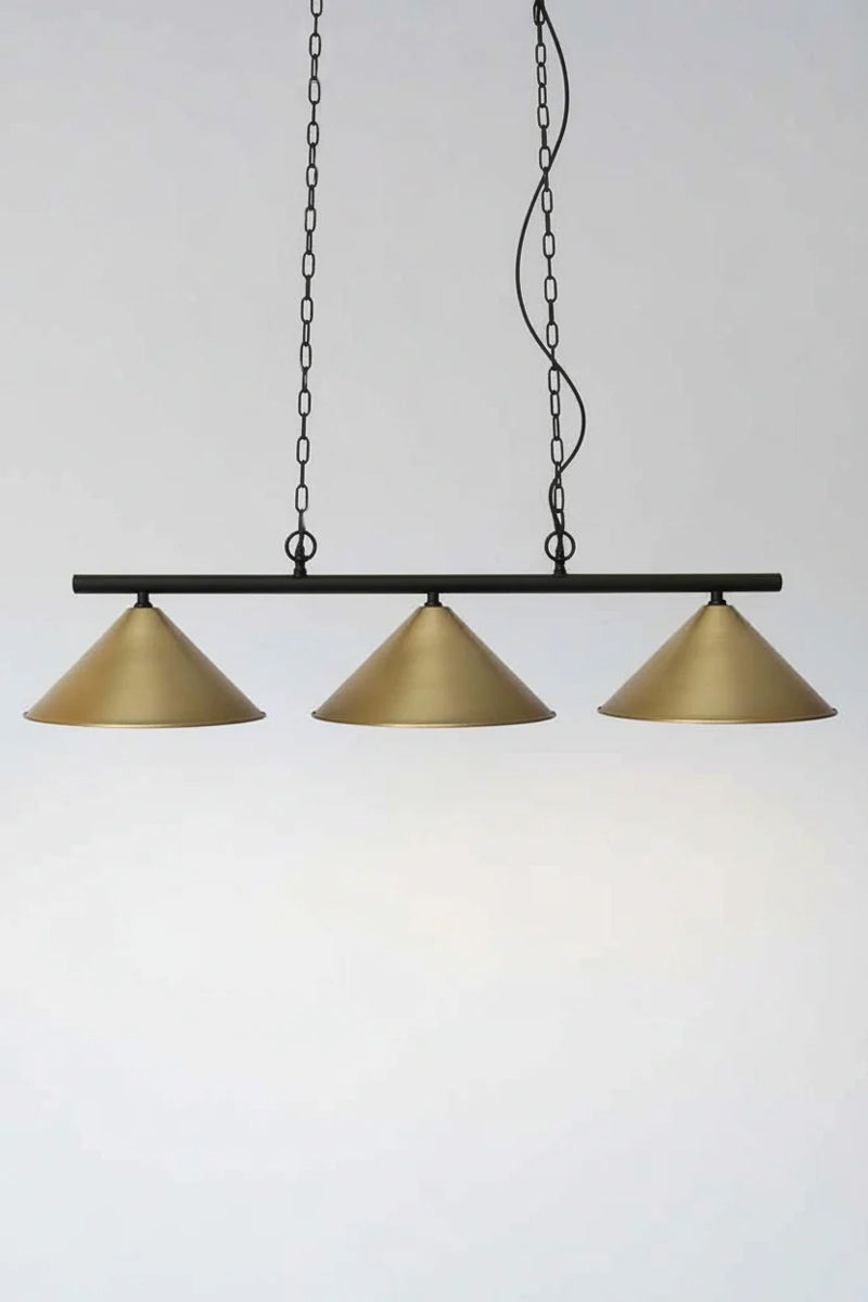 Three Large Bright Brass Conce shades on a black linear fixture with chain and cord suspension. 
