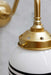 Glass ball wall light in satin brass finish close up