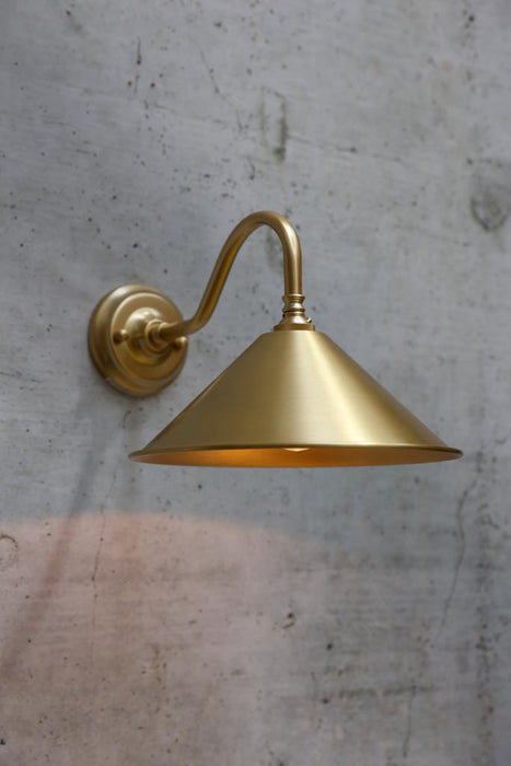 Cone wall light in satin brass finish with small bright brass shade