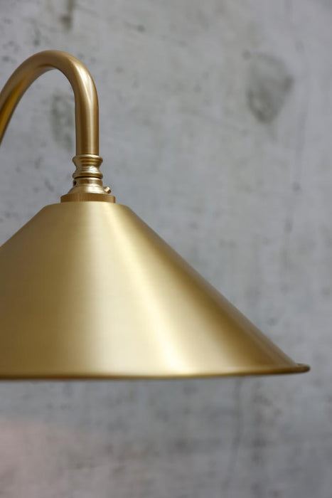 Close up on satin brass finish wall sconce
