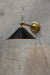 Gold/brass steel arm wall light with black steel shade
