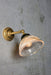 Vintage style wall light with gold/brass wall arm.