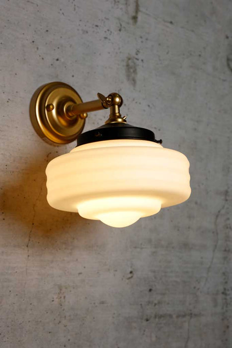 Schoolhouse wall light in gold finish with small shade