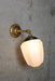 Wall light with short straight arm in gold/ brass finish
