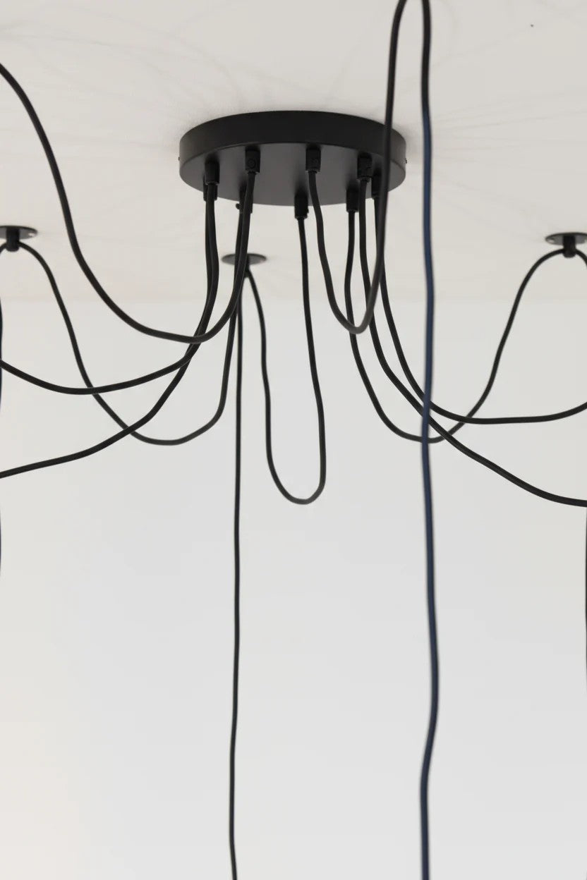 200mm circular black ceiling rose with 9 black cloth cords on a white ceiling. 