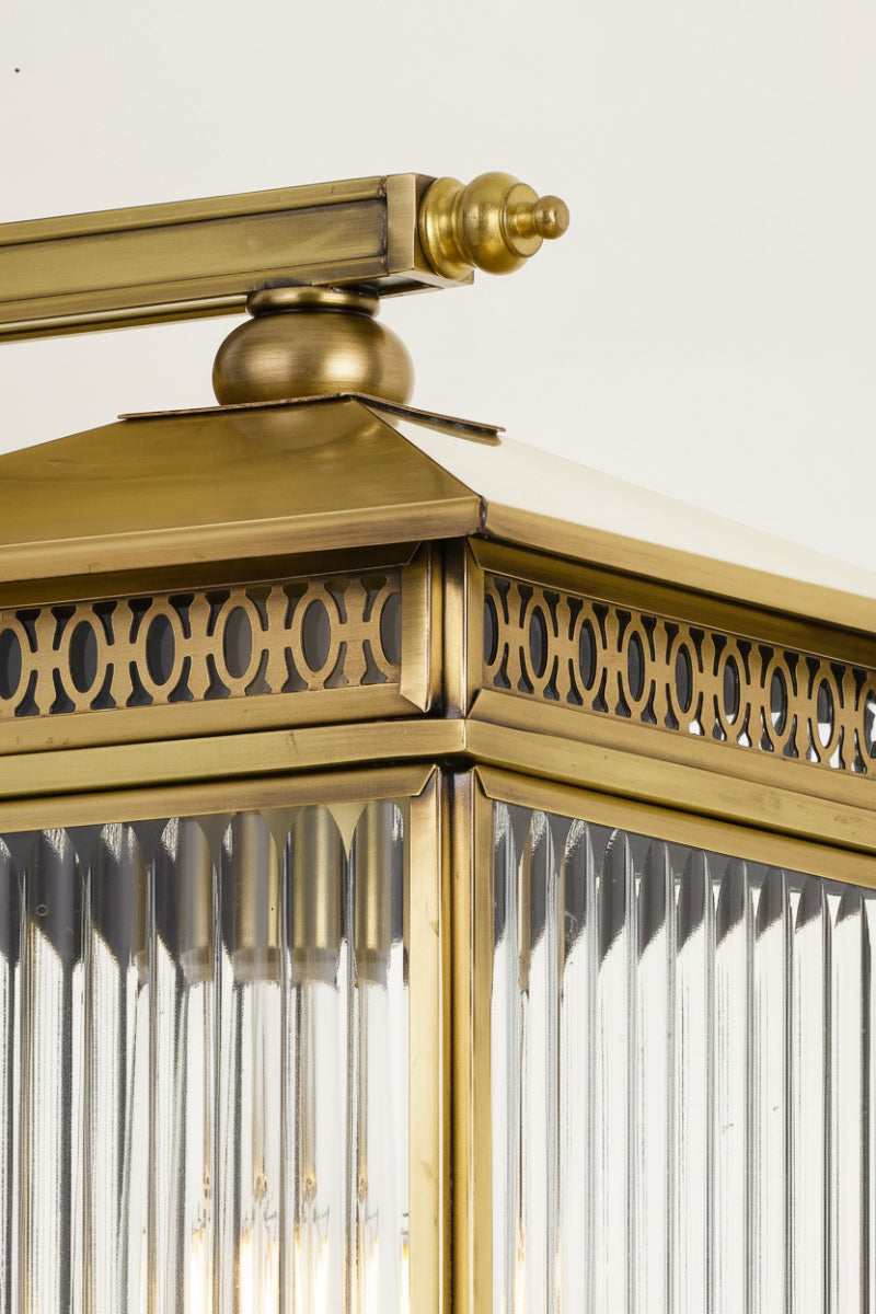 Close up of the small brass wall light with clear fluted glass. 