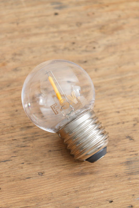 Clear glass G45 bulb with LED element and an E27 base. 