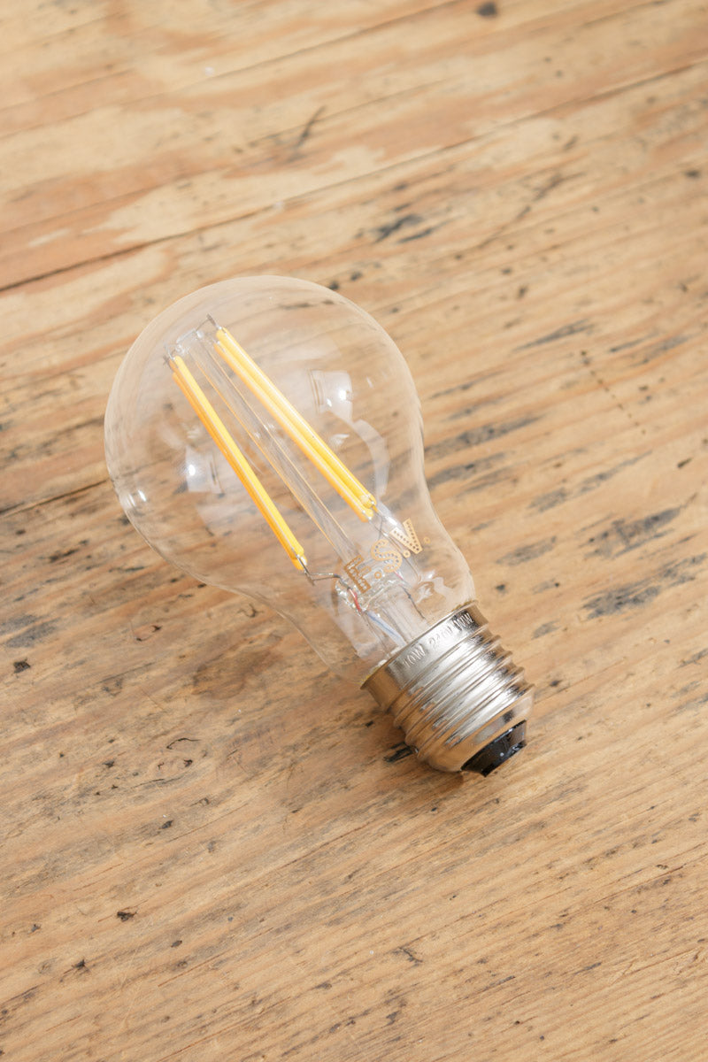 E27 bulb base with clear glass and LED filaments. 
