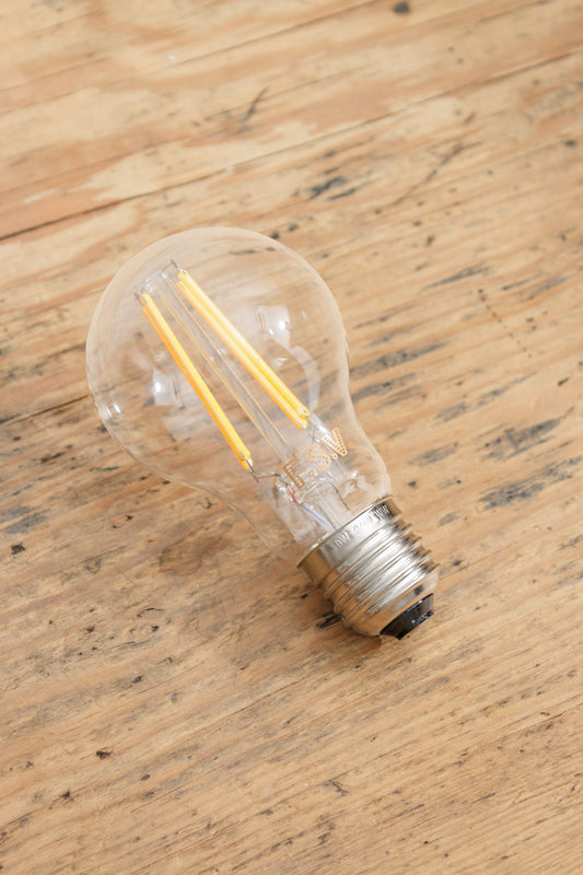 E27 bulb base with clear glass and LED filaments. 