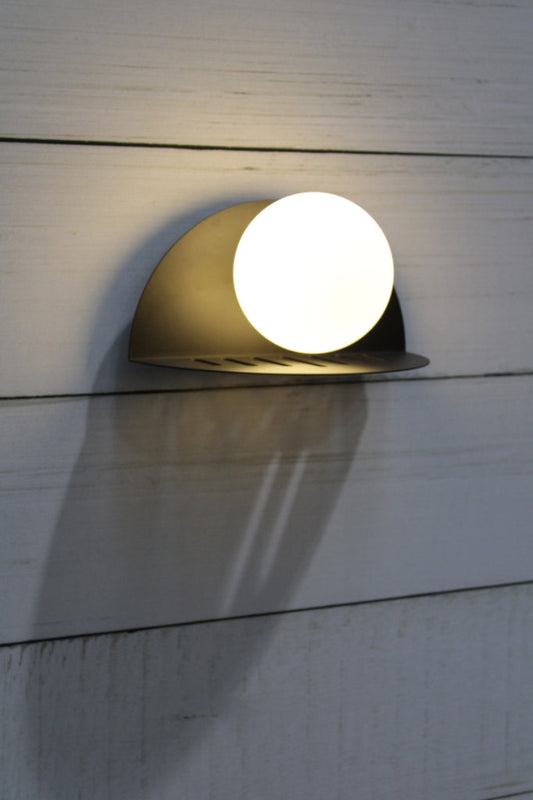 Metal 90 degree curved wall bracket in black with an opal glass ball shade. 