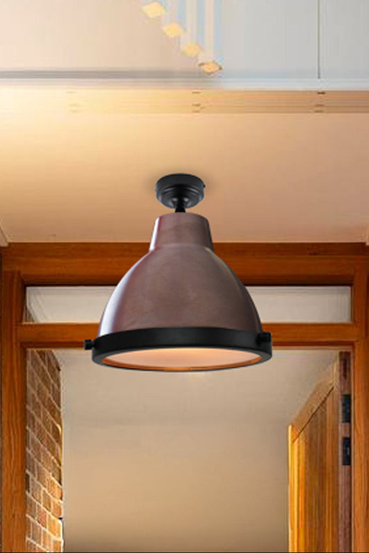 Aged brass loft light with glass cover in an entry way. 
