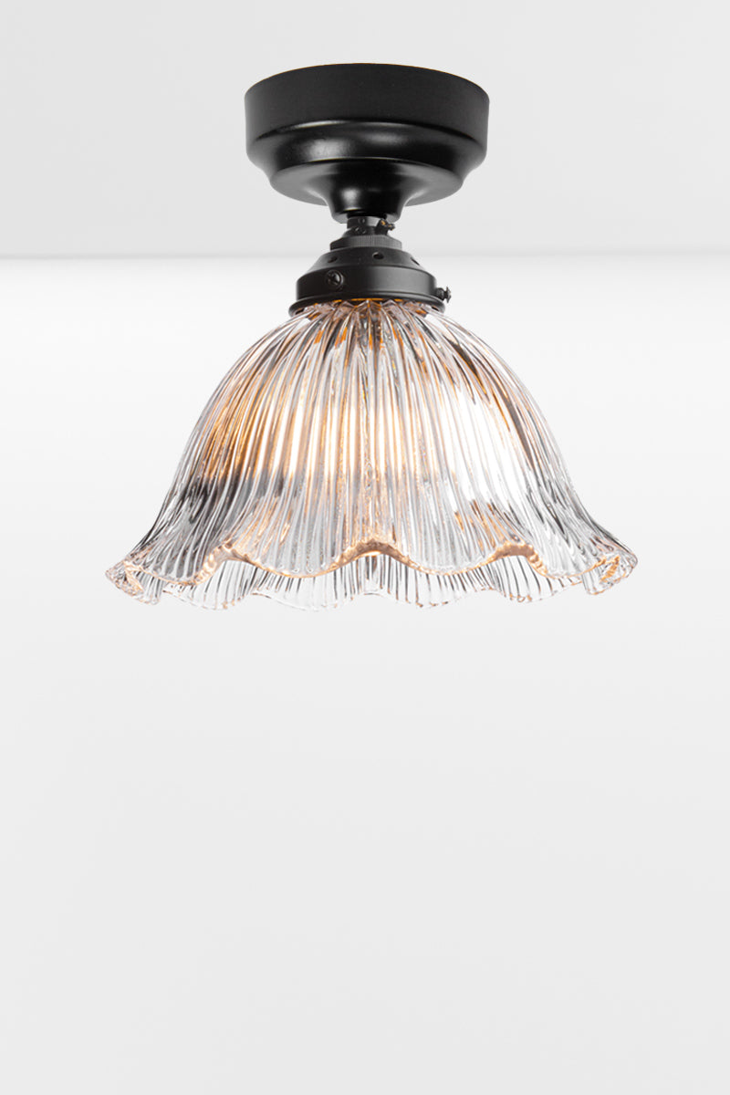 Holophane clear shade with a frilled edge paired with a black batten holder. 