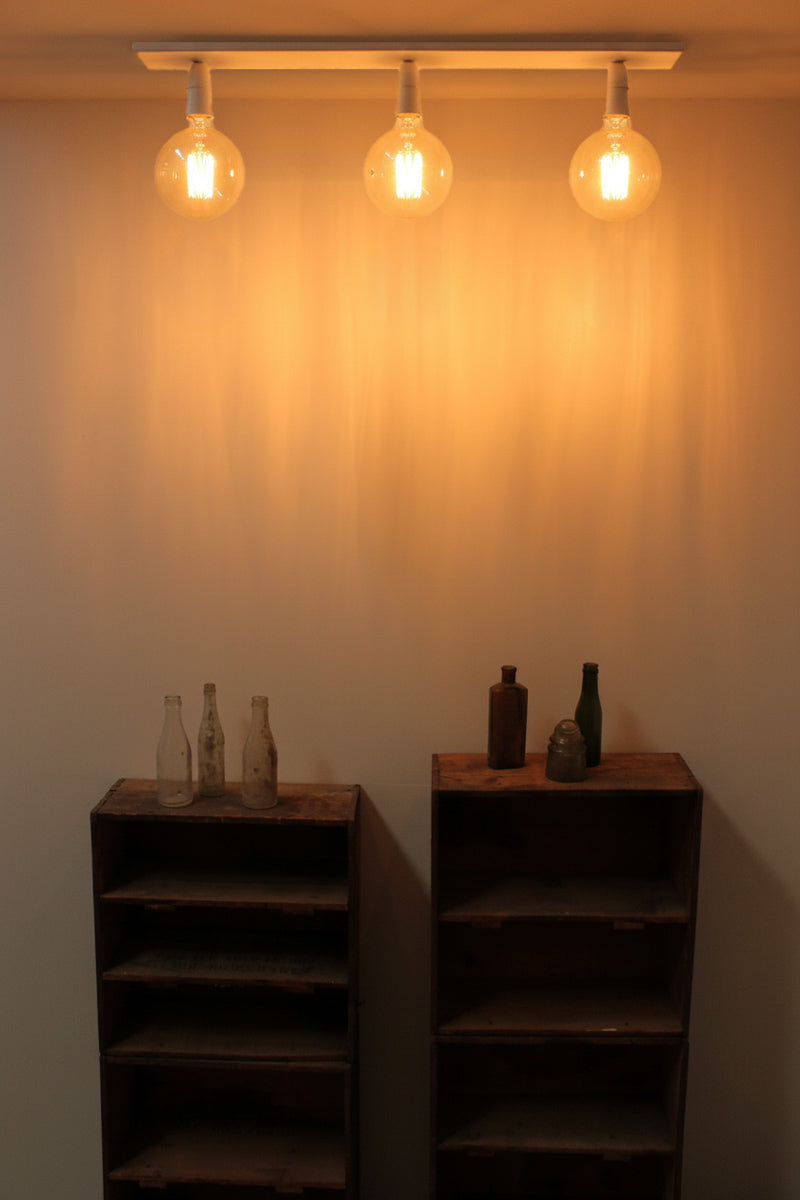 White 3 light linear flush mount light, bare bulb. 
