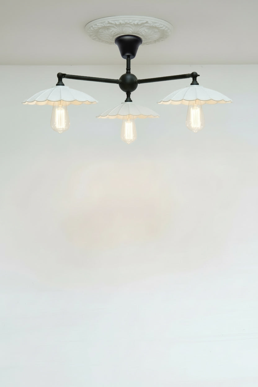 Black steel 3 arm flush mount with hite steel umbrella shades and tear drop bulbs