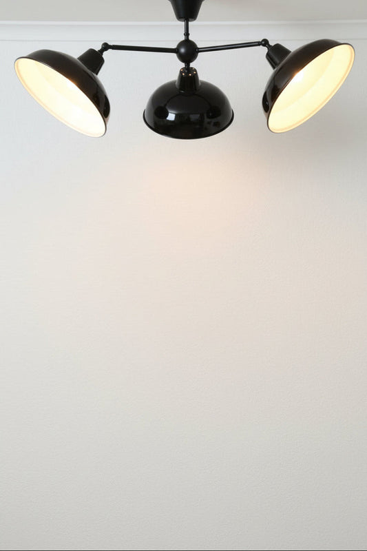 Blacks 3 arm stell fixture with black warehouse shades showcasing their ability to tilt. 
