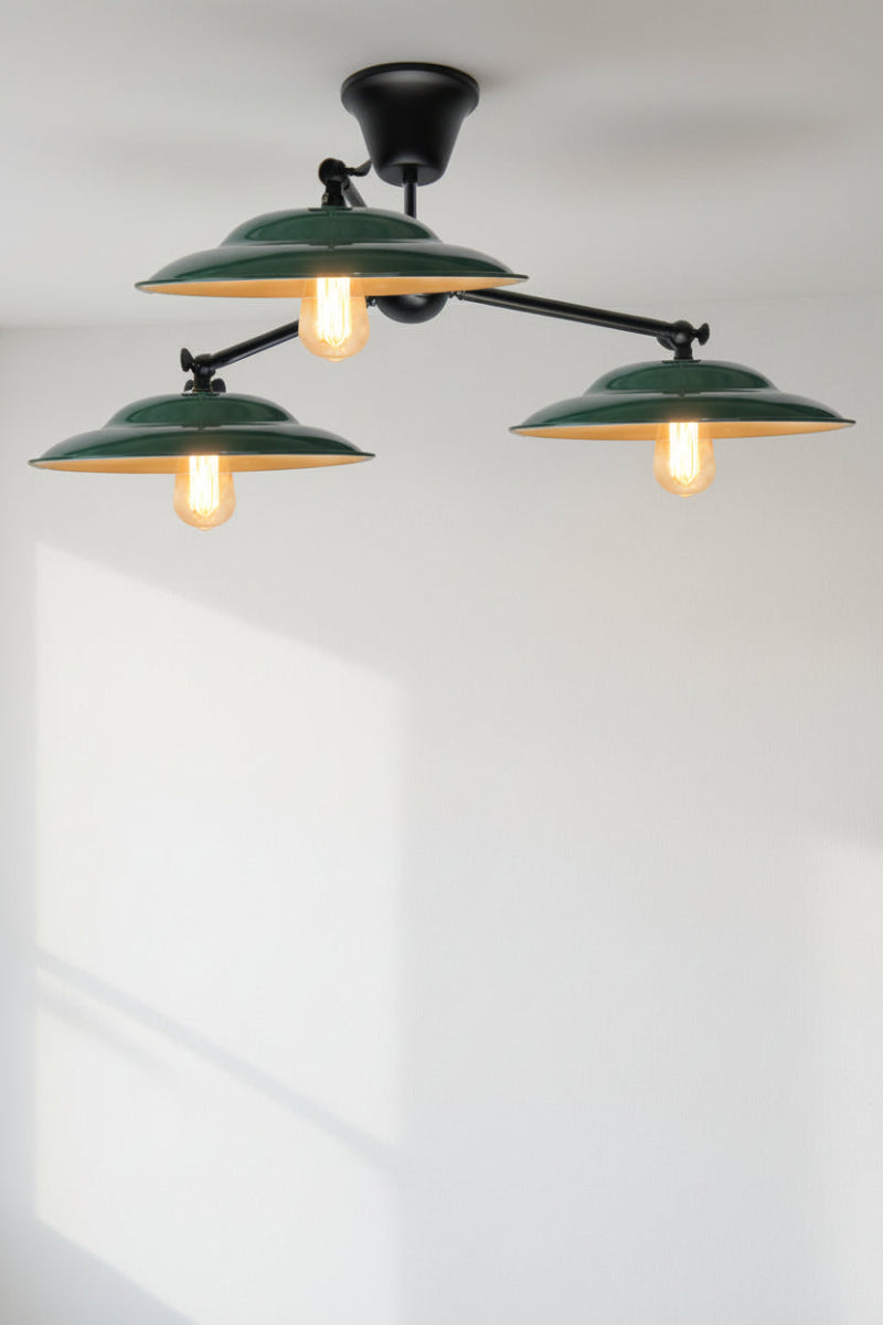 Green barn shades on a triple black close to ceiling fixture. 
