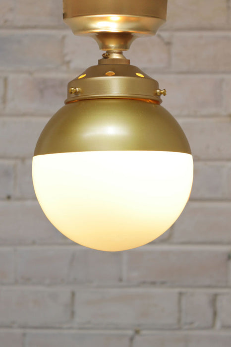 Crown Sphere Flush Mount Light with a gold mount with a gold gallery and a gold and opal shade