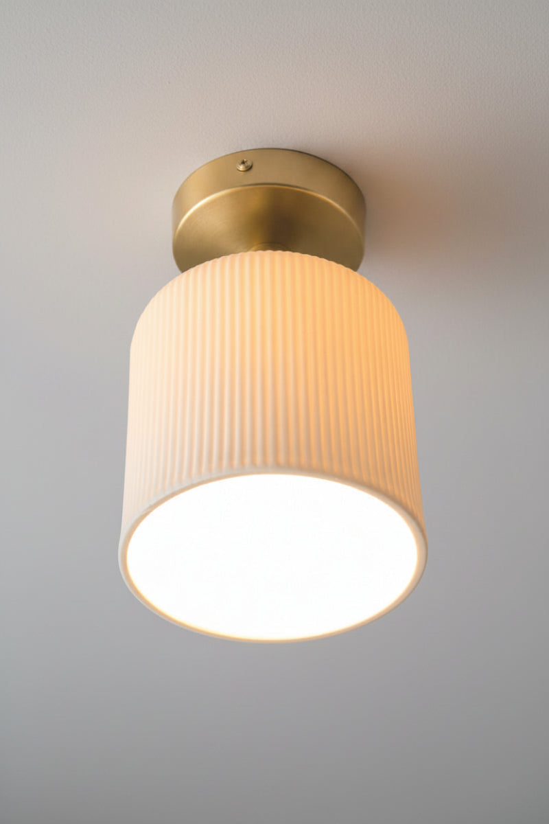 Ceramic flush mount light with a gold/brass ceiling rose. 
