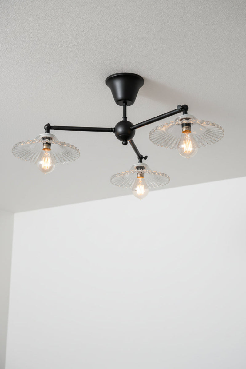 Black three light straight arm flushmount woth scalloped glass shades