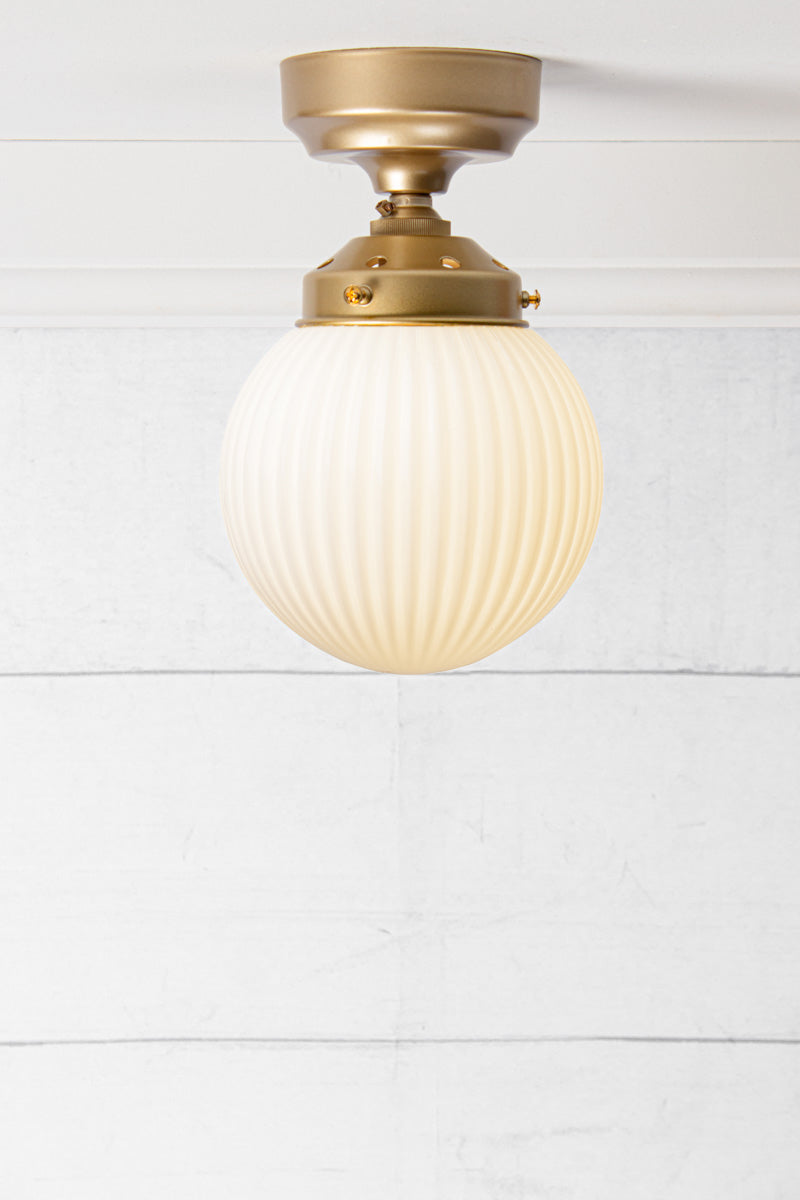 Opal reeded glass ball batten light with gold/brass metalware