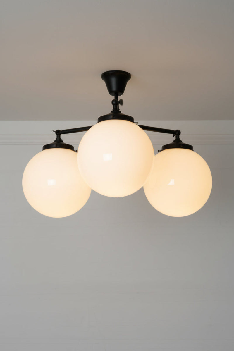 Medium glass ball ceiling light with triple black straight arm