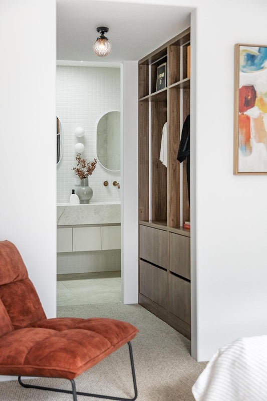 Vintage inspired decorative glass gall shade in clear with a black close to ceiling batten holder in a walk-in robe. 