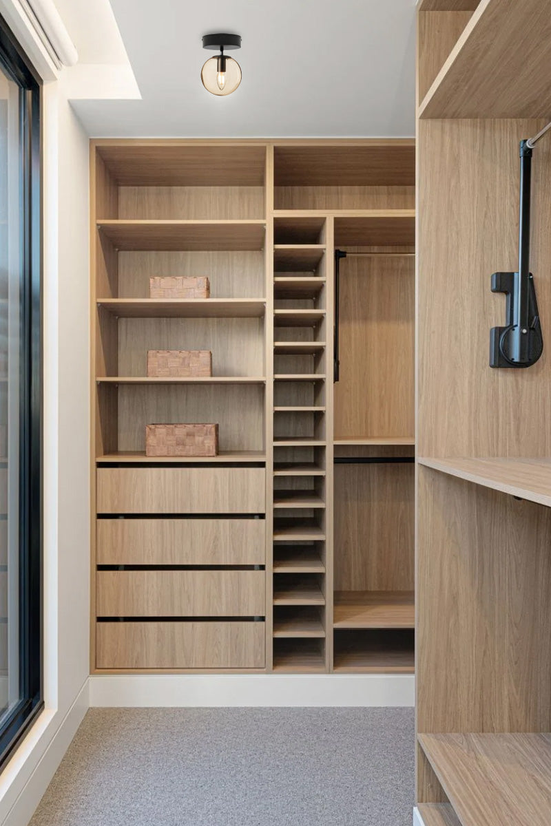 Amber glass orb shade ceiling light in a tember clad dressing room. 