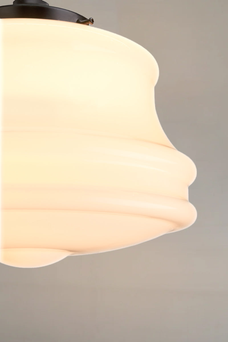 A close-up of shade features graceful tiered curves in handmade opal glass 