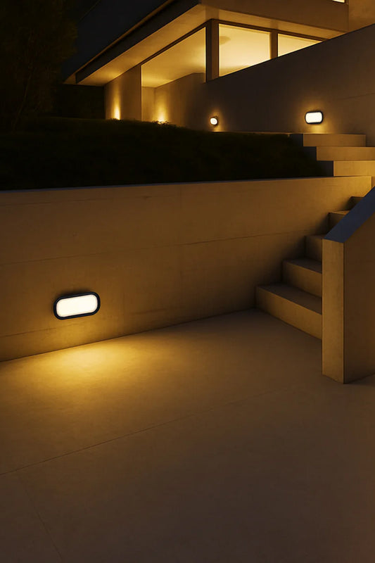 Multiple black framed polycarbonate rectanguler bunker lights used to illuminates outdoor staircase of a modern building. 