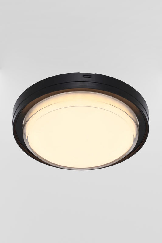 Round polycarbonate bunker light with black frame and LED light source. 
