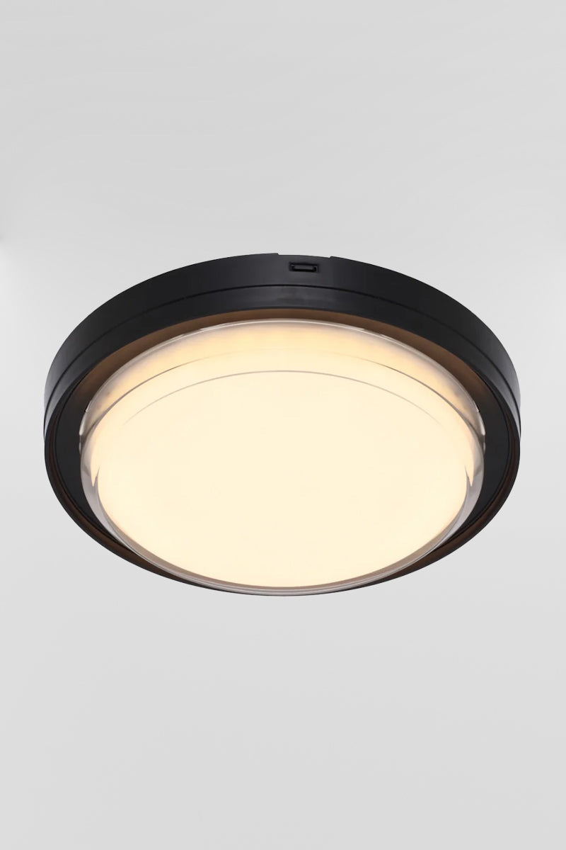 Round polycarbonate bunker light with black frame and LED light source. 
