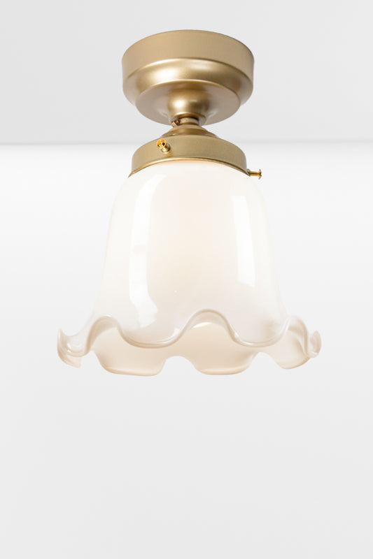 Opal frill edged shade on a gold/brass batten holder. 