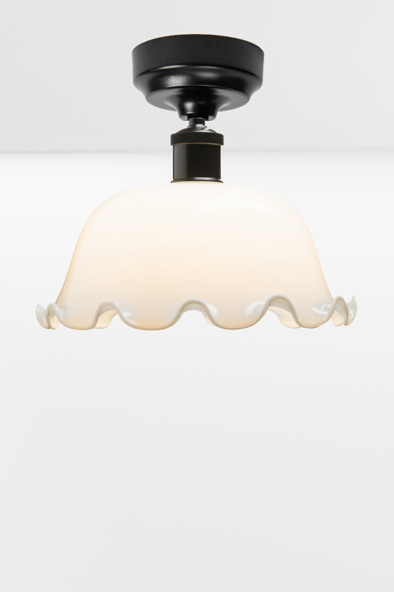 Black batten older paired with an opal dome shade with frilled edging. 
