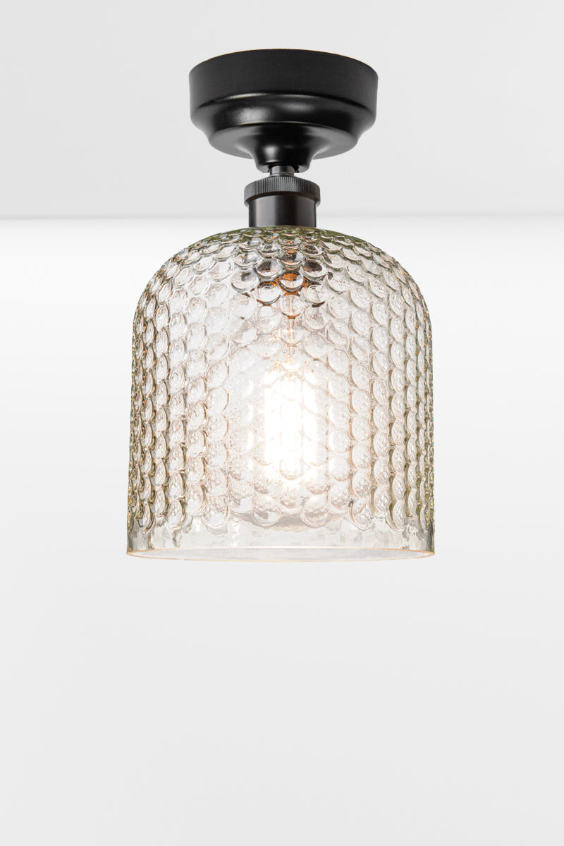 Clear dimpled glass shade with a black batten holder. 