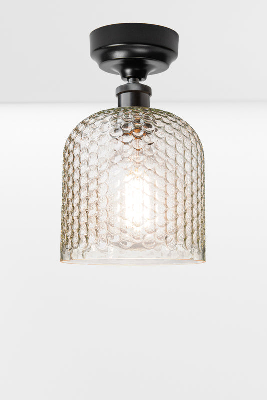 Clear dimpled glass shade with a black batten holder. 
