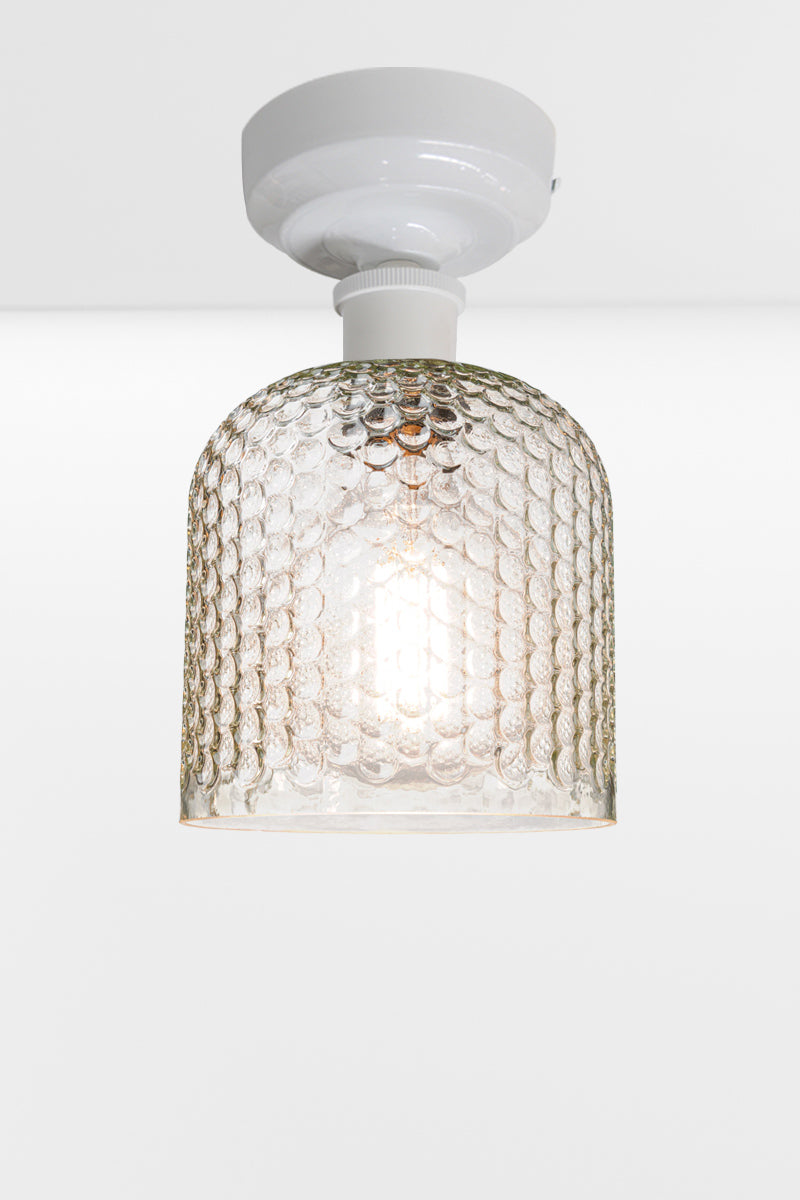 Clear dimpled glass shade with a white batten holder. 