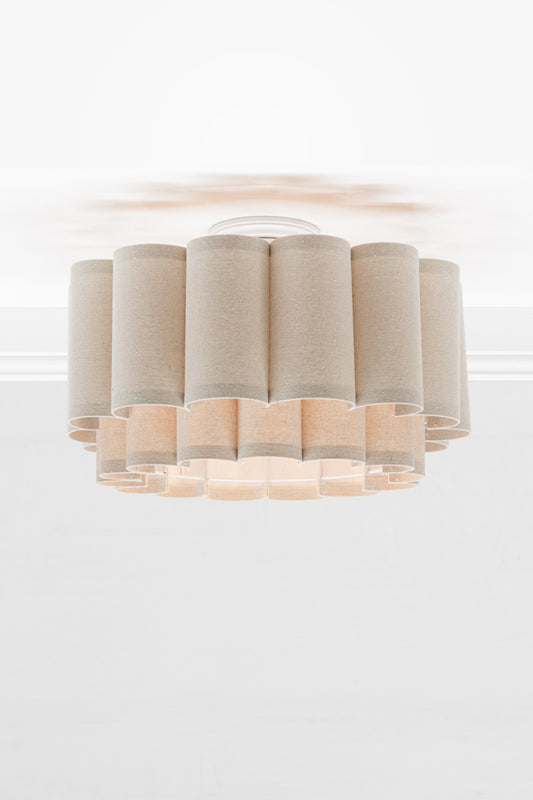 Neutral toned fabric shade with two teirs in a scallopped formation, paired with a white batten holder.