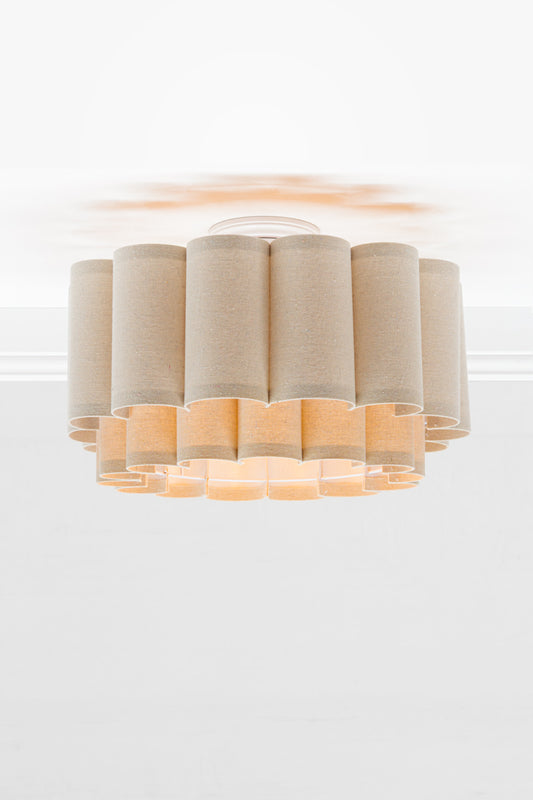 Neutral toned fabric shade with two teirs in a scallopped formation, paired with a white batten holder.
