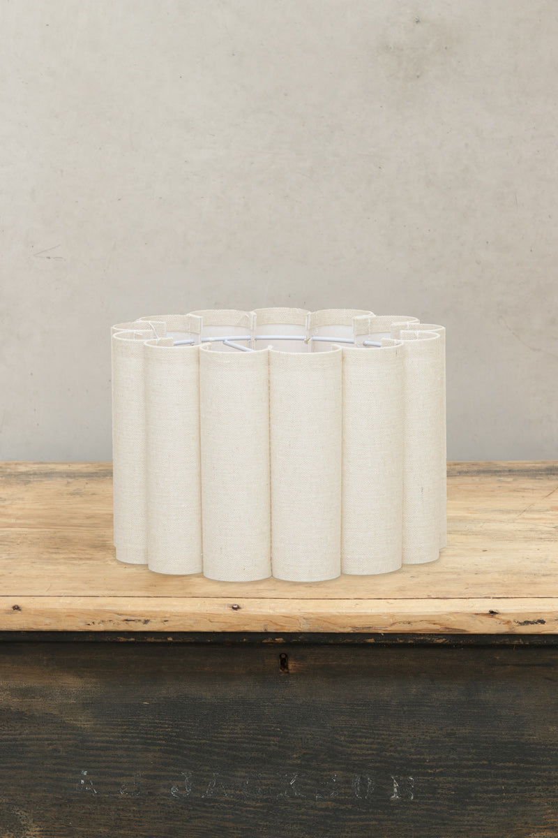 Small fabric scalloped shade with white wire frame. 